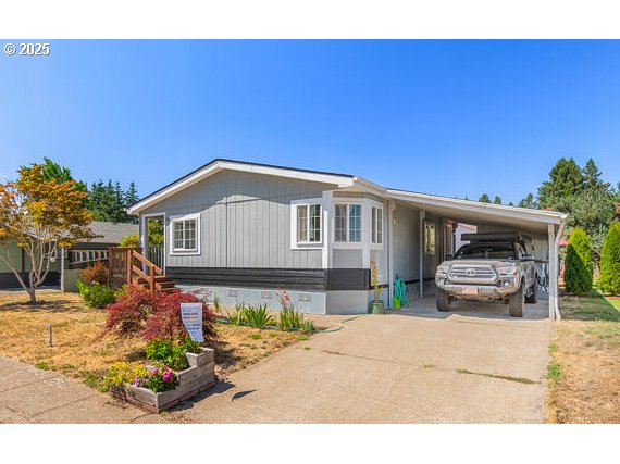 310 Pitney Lane, Unit 40 Junction City, OR 97448 - Photo 2 of 36 a front view of a house with a garden
