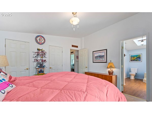 310 Pitney Lane, Unit 40 Junction City, OR 97448 - Photo 23 of 36 a bedroom with a bed and a lamp