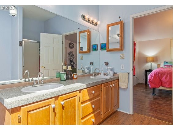 310 Pitney Lane, Unit 40 Junction City, OR 97448 - Photo 25 of 36 a bathroom with a granite countertop sink and a mirror
