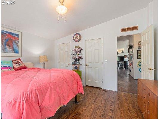 310 Pitney Lane, Unit 40 Junction City, OR 97448 - Photo 26 of 36 a bed room with a bed and a chandelier