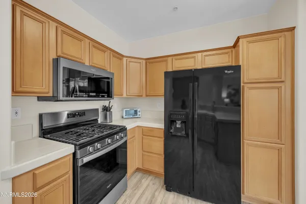 a kitchen with a refrigerator stove and microwave