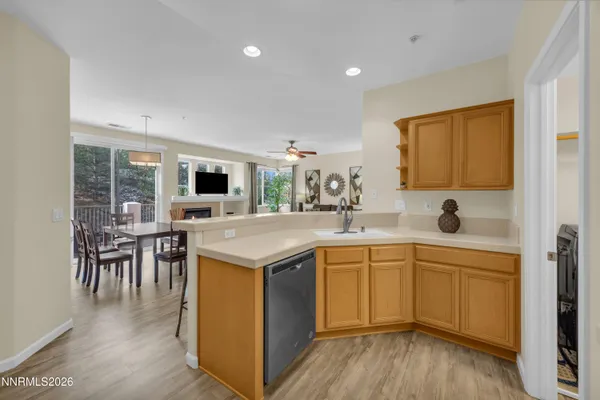 a kitchen with a sink cabinets and wooden floor
