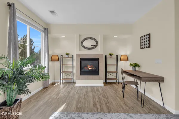 a living room with furniture and a fireplace