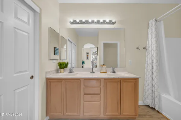 a bathroom with a double vanity sink and a mirror