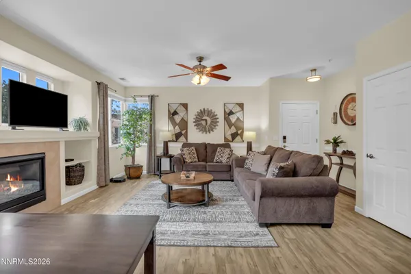 a living room with fireplace furniture and a flat screen tv