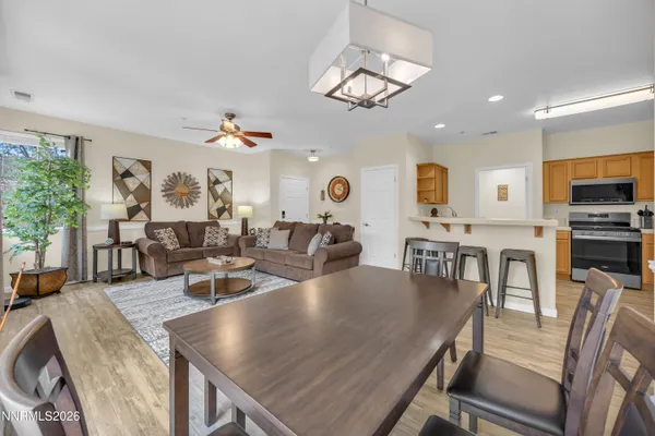 a view of a dining room with furniture and a chandelier