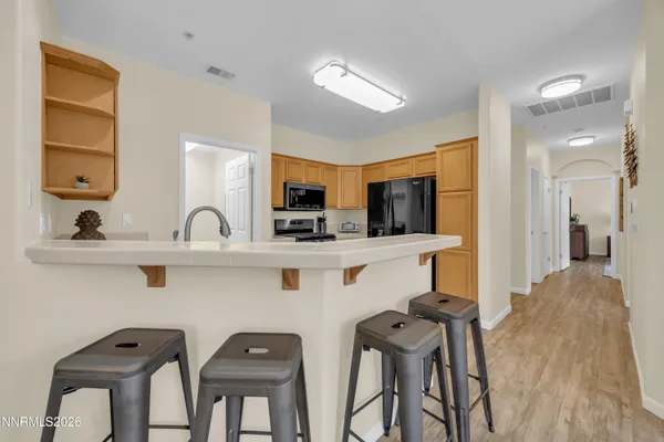 a kitchen with stainless steel appliances a sink and a refrigerator