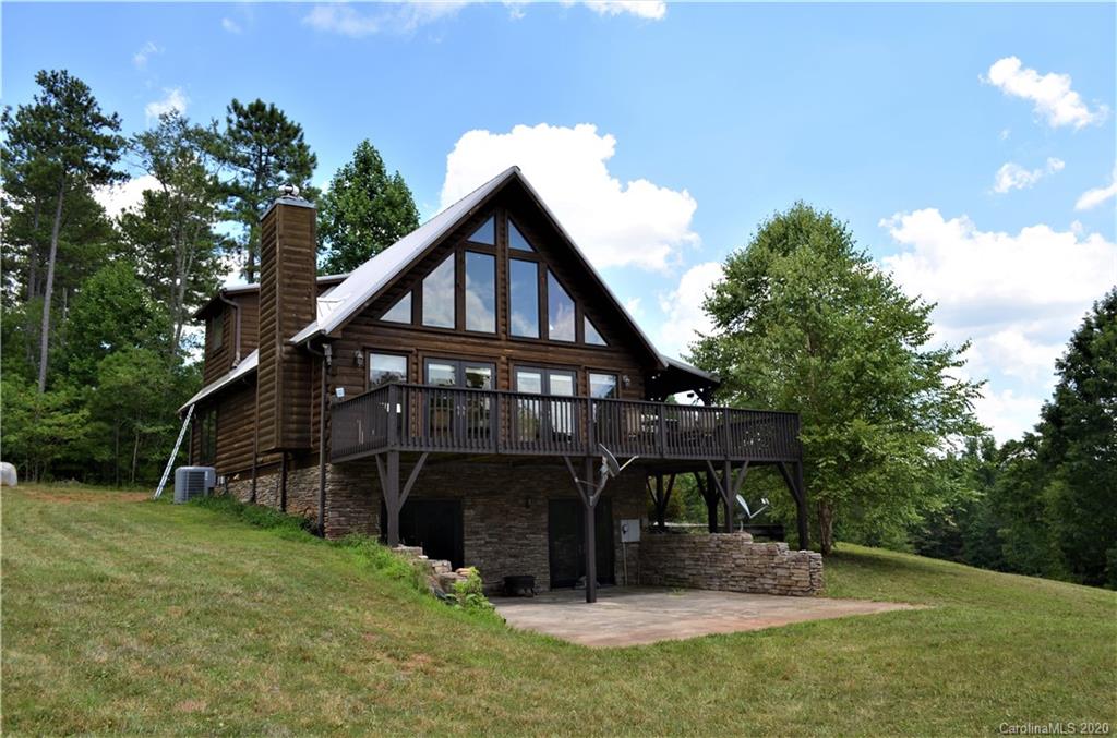 208 Loblolly Ln Mill Spring Mill Spring, NC 28756 - Photo 2 of 46 a view of a wooden house with a yard