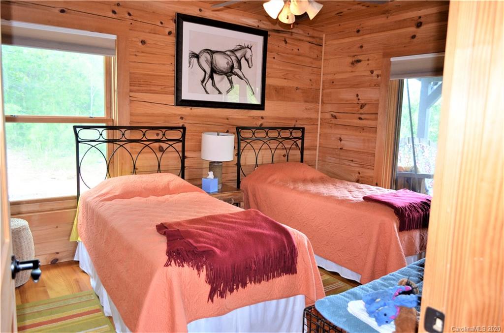 208 Loblolly Ln Mill Spring Mill Spring, NC 28756 - Photo 20 of 46 a bedroom with two beds and painting on the wall