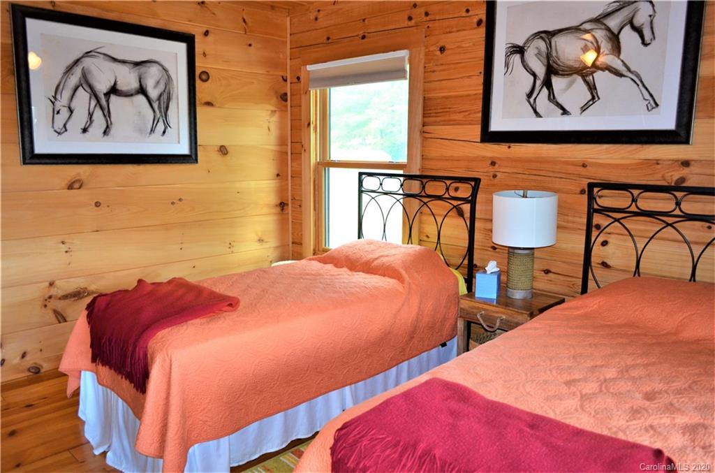 208 Loblolly Ln Mill Spring Mill Spring, NC 28756 - Photo 21 of 46 a bedroom with two beds and painting on the wall