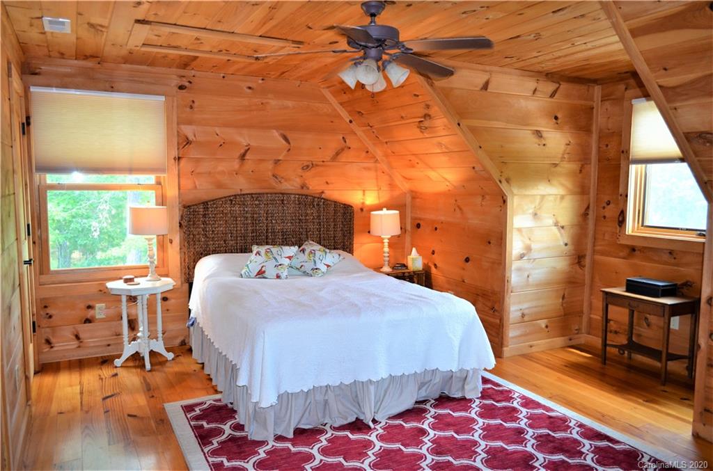 208 Loblolly Ln Mill Spring Mill Spring, NC 28756 - Photo 26 of 46 a bed sitting in a bedroom next to a window