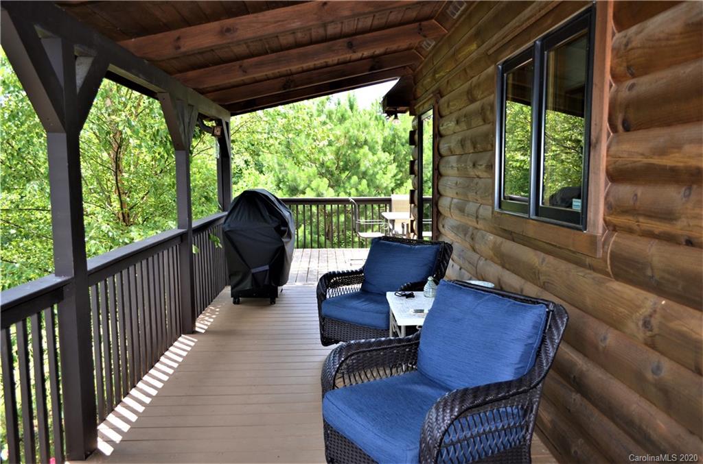 208 Loblolly Ln Mill Spring Mill Spring, NC 28756 - Photo 7 of 46 a view of a chairs and table in patio with a yard