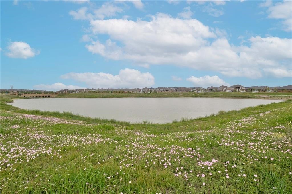 806 Pepperbark Loop Buda, TX 78610 - Photo 27 of 39 a view of a lake with houses in the back