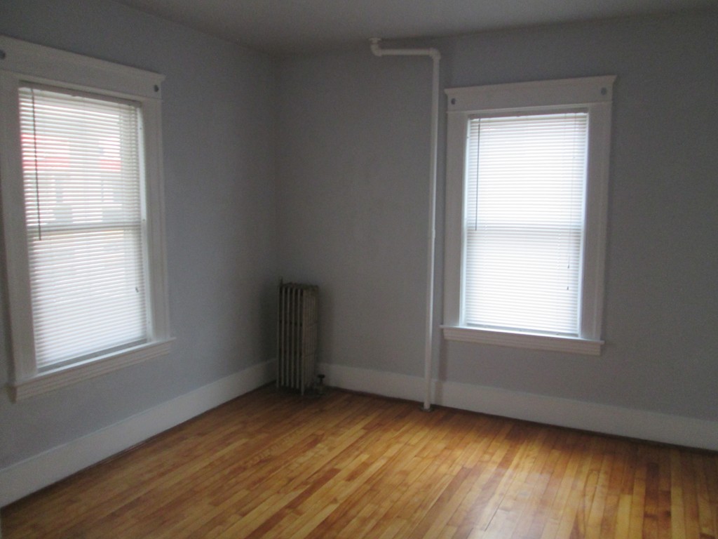 26 Sylvan Street Worcester, MA 01603 - Photo 12 of 27 an empty room with wooden floor and windows