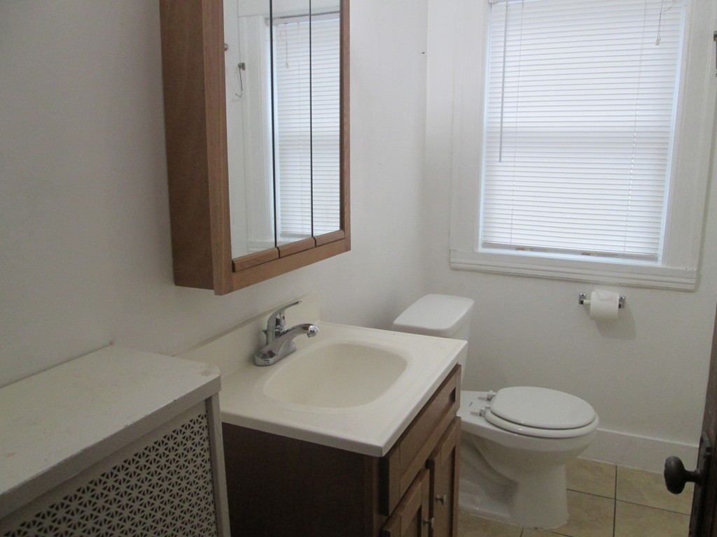 26 Sylvan Street Worcester, MA 01603 - Photo 14 of 27 a bathroom with a sink a toilet and a window