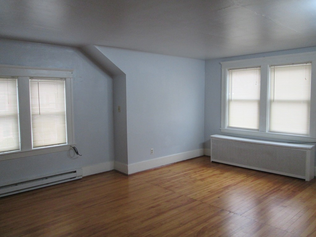 26 Sylvan Street Worcester, MA 01603 - Photo 18 of 27 an empty room with wooden floor and windows