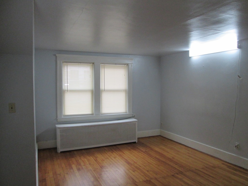 26 Sylvan Street Worcester, MA 01603 - Photo 19 of 27 an empty room with wooden floor and windows