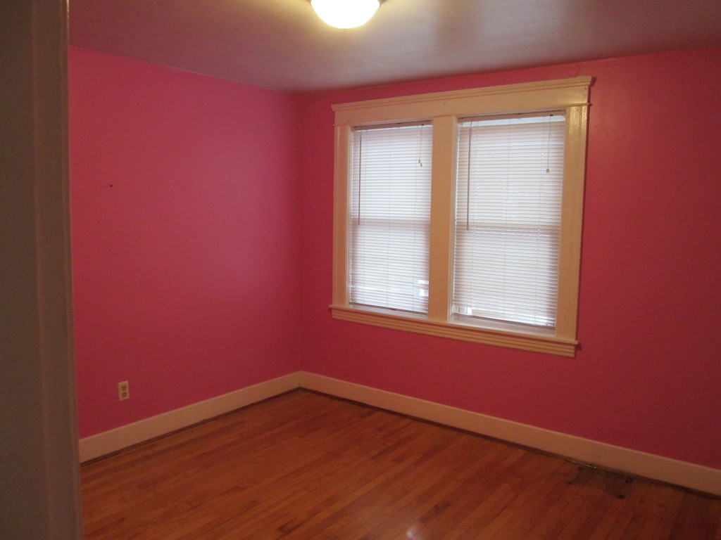 26 Sylvan Street Worcester, MA 01603 - Photo 23 of 27 an empty room with wooden floor and windows