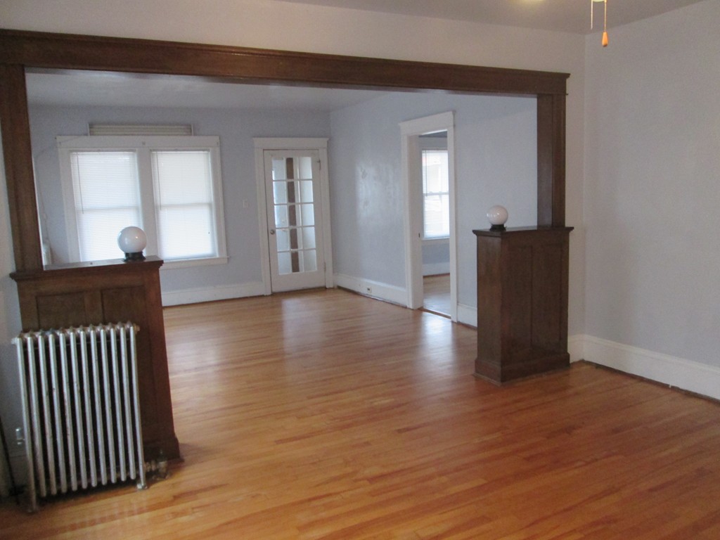 26 Sylvan Street Worcester, MA 01603 - Photo 6 of 27 an empty room with wooden floor and windows