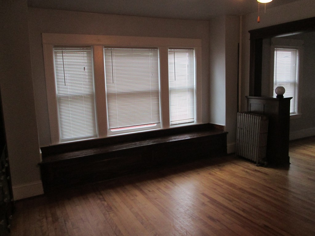 26 Sylvan Street Worcester, MA 01603 - Photo 7 of 27 a room with wooden floor and a window
