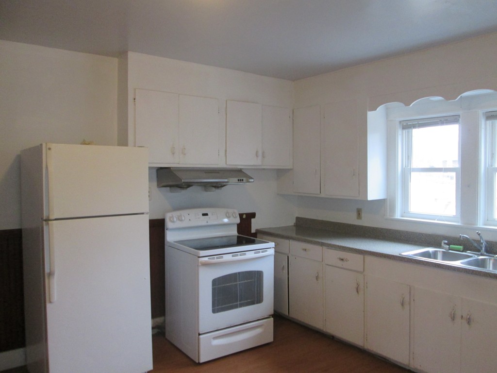 26 Sylvan Street Worcester, MA 01603 - Photo 9 of 27 a kitchen with cabinets appliances a sink and a window