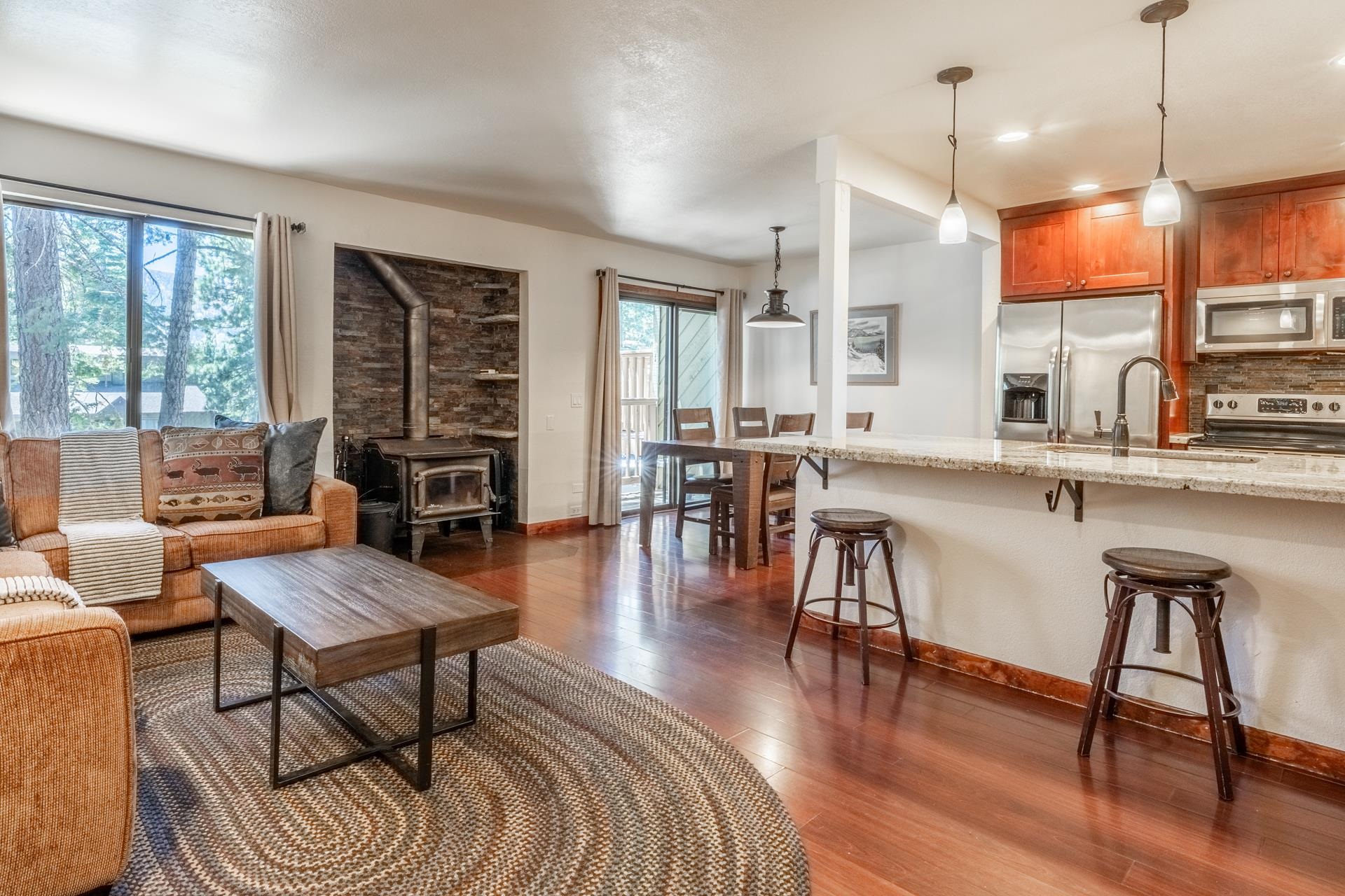 a living room with furniture a wooden floor and a large window