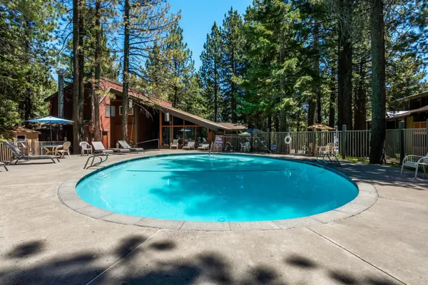 a swimming pool with outdoor seating and yard