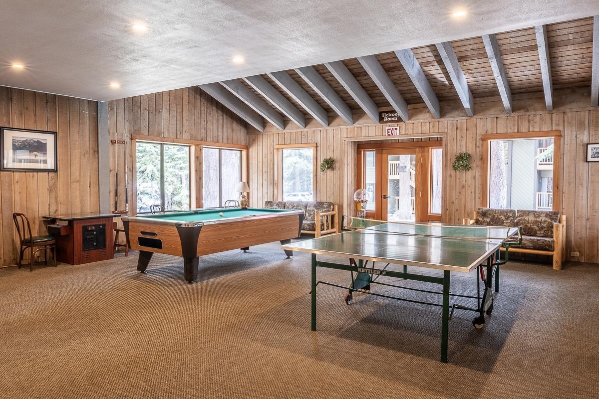 152 Viewpoint Road, Unit 115 Mammoth Lakes, CA 93546 - Photo 36 of 45 a living room with furniture a table and a large window
