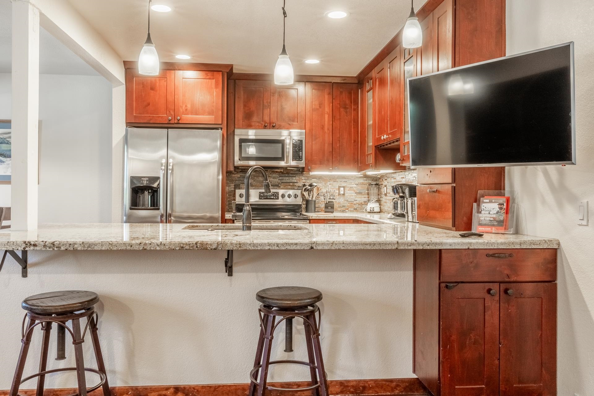 152 Viewpoint Road, Unit 115 Mammoth Lakes, CA 93546 - Photo 4 of 45 a kitchen with stainless steel appliances a sink cabinets and wooden floor