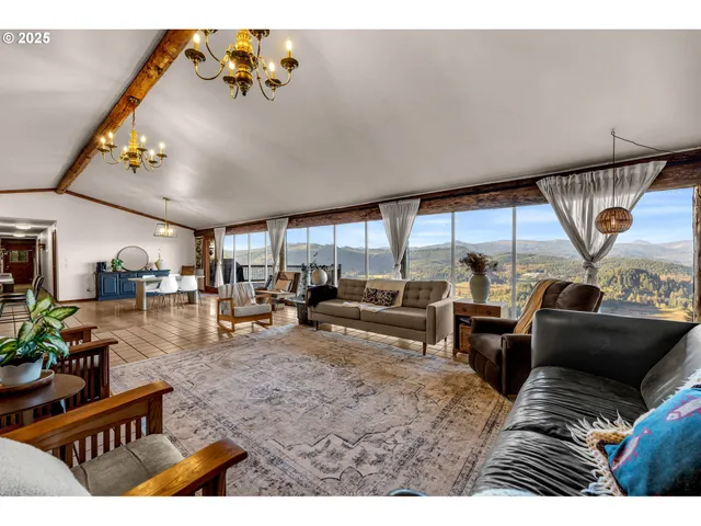 a living room with lots of furniture and a large window