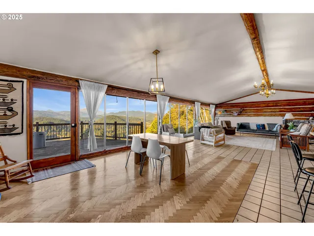 a dining room with furniture a chandelier and wooden floor