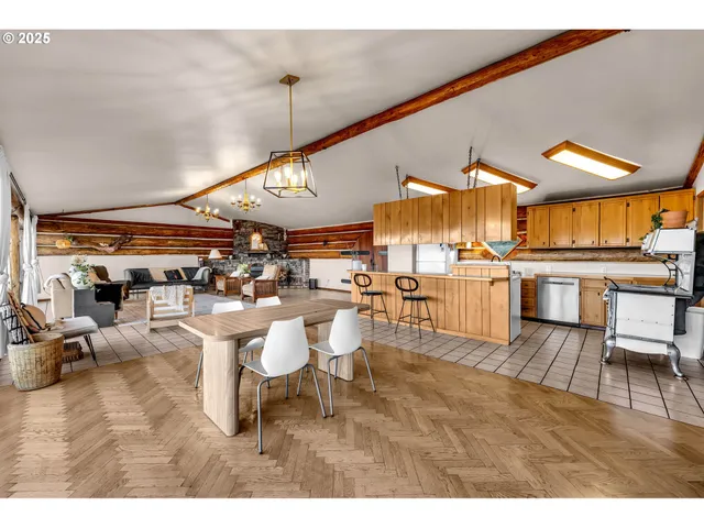 a living room with lots of furniture and view of kitchen