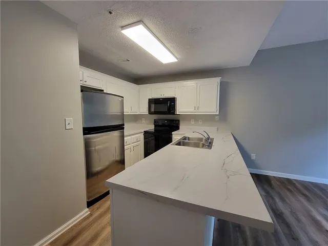a kitchen with a refrigerator and a sink