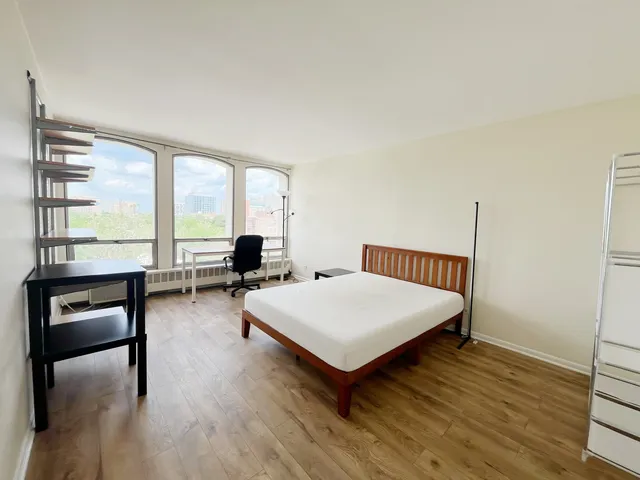 a living room with furniture and large windows