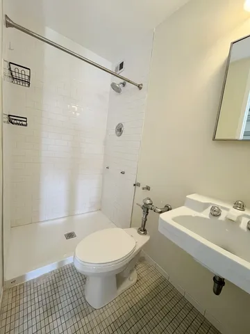 a white toilet sitting next to a bathroom sink