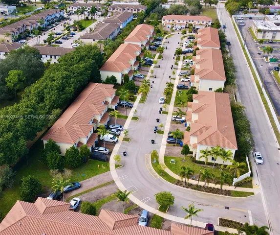an aerial view of residential houses with outdoor space