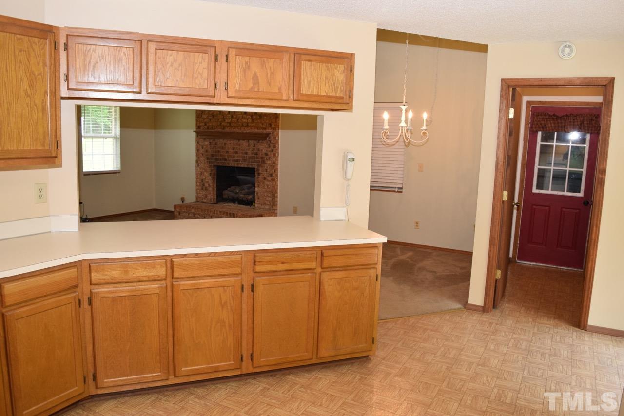 5100 Hurmax Lane Raleigh, NC 27610 - Photo 8 of 18 a kitchen with cabinets and a refrigerator