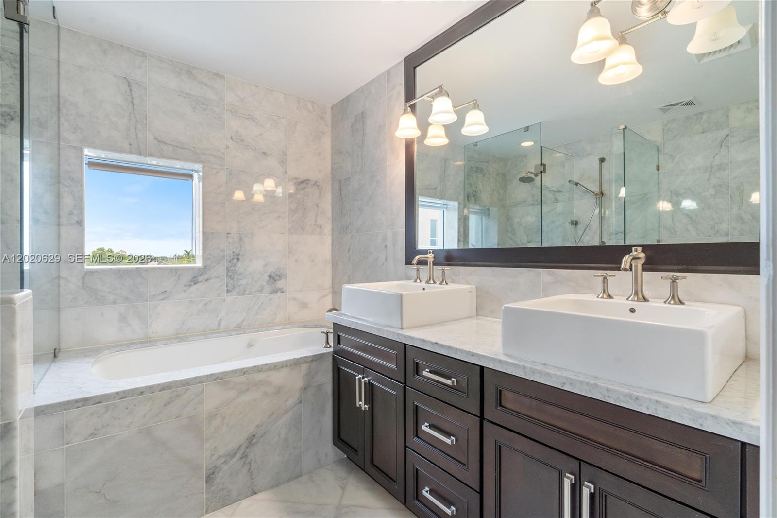 455 East Palmetto Park Road, Unit 4 Boca Raton, FL 33432 - Photo 16 of 30 a bathroom with a sink double vanity granite tub and shower