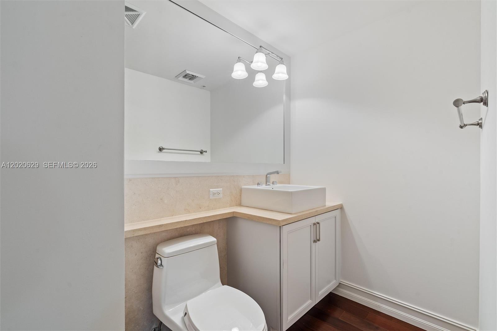 455 East Palmetto Park Road, Unit 4 Boca Raton, FL 33432 - Photo 18 of 30 a bathroom with a toilet sink and mirror