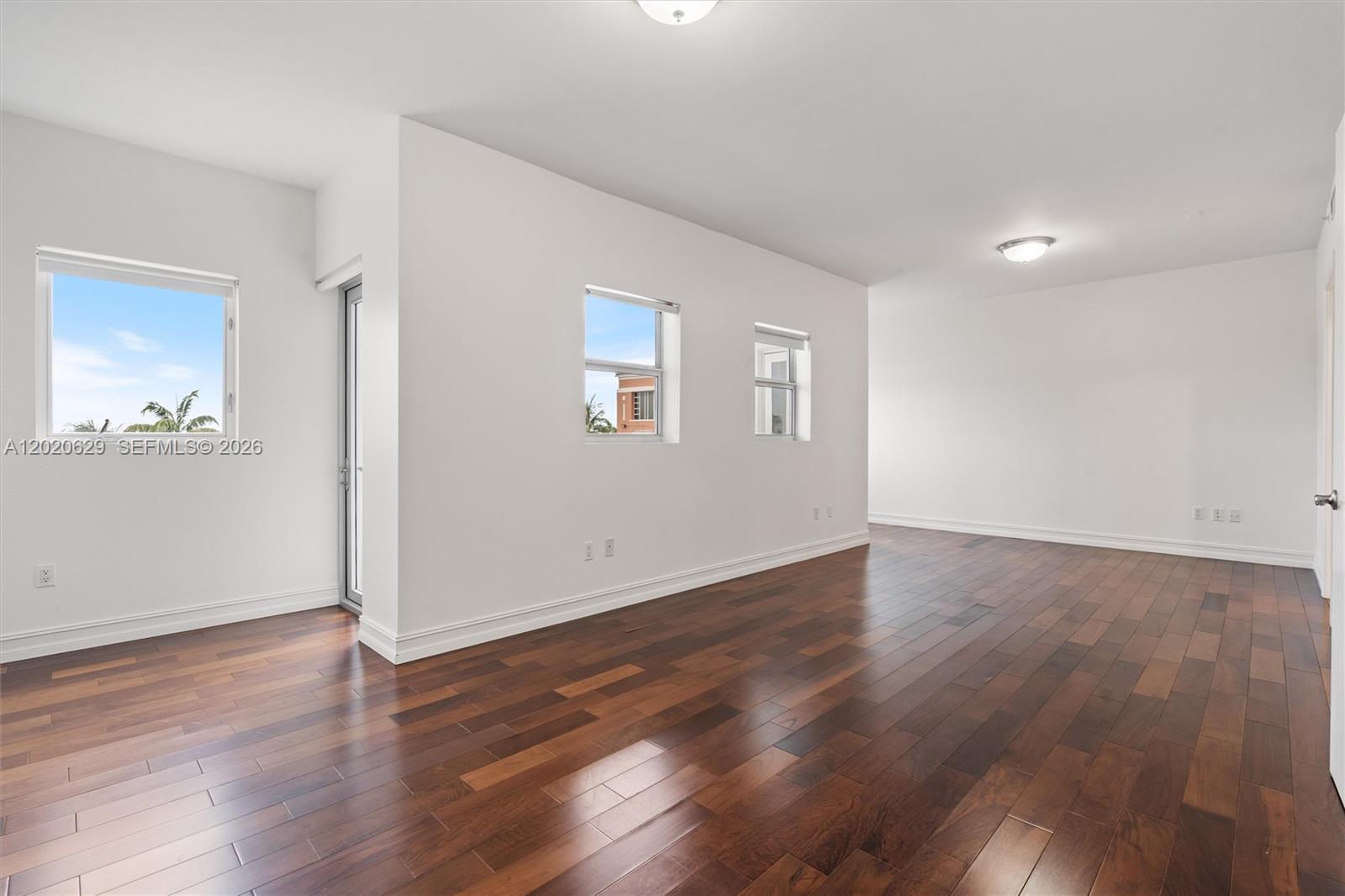 455 East Palmetto Park Road, Unit 4 Boca Raton, FL 33432 - Photo 20 of 30 an empty room with wooden floor and windows