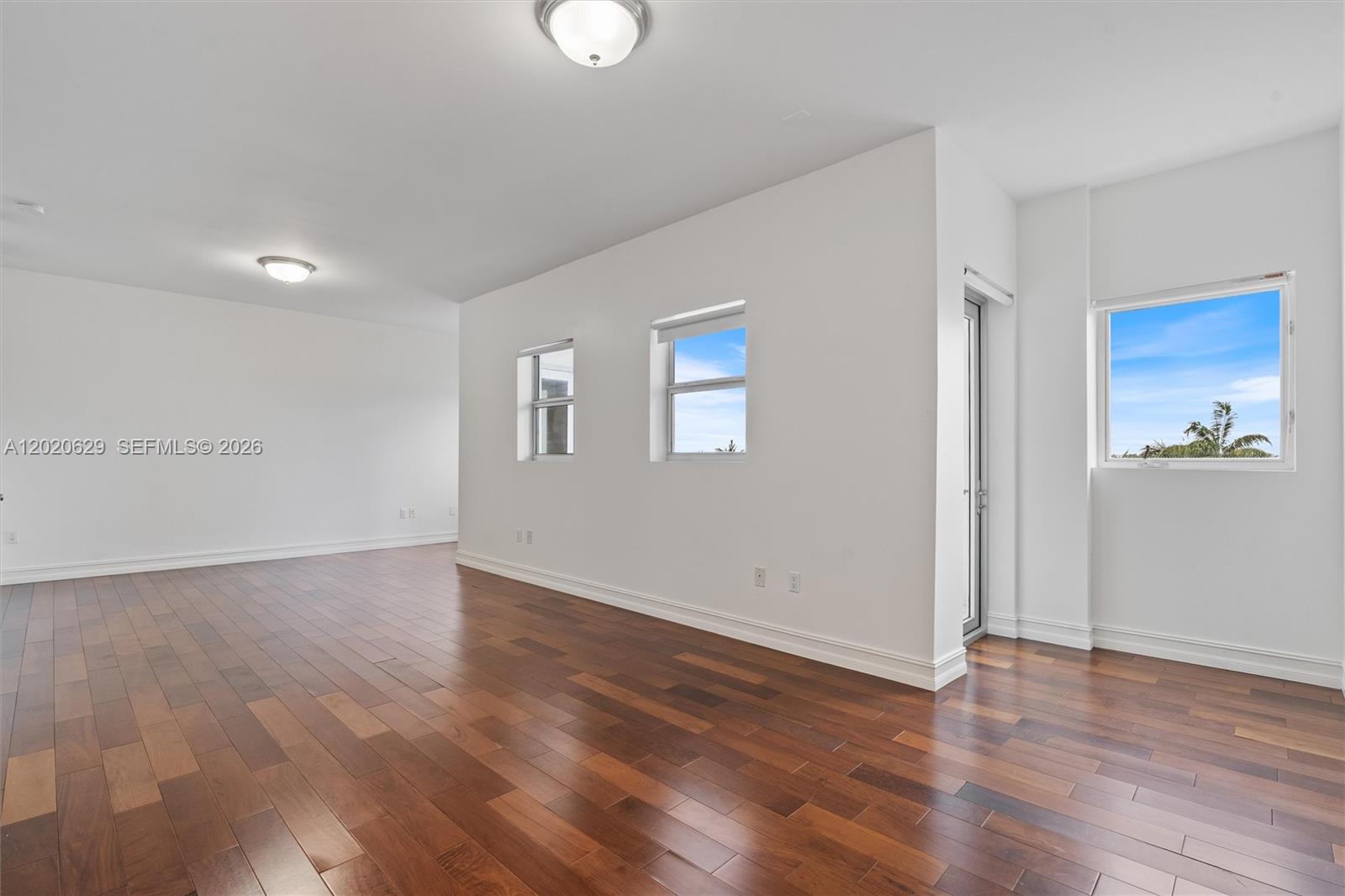 455 East Palmetto Park Road, Unit 4 Boca Raton, FL 33432 - Photo 22 of 30 a view of an empty room with wooden floor and a window