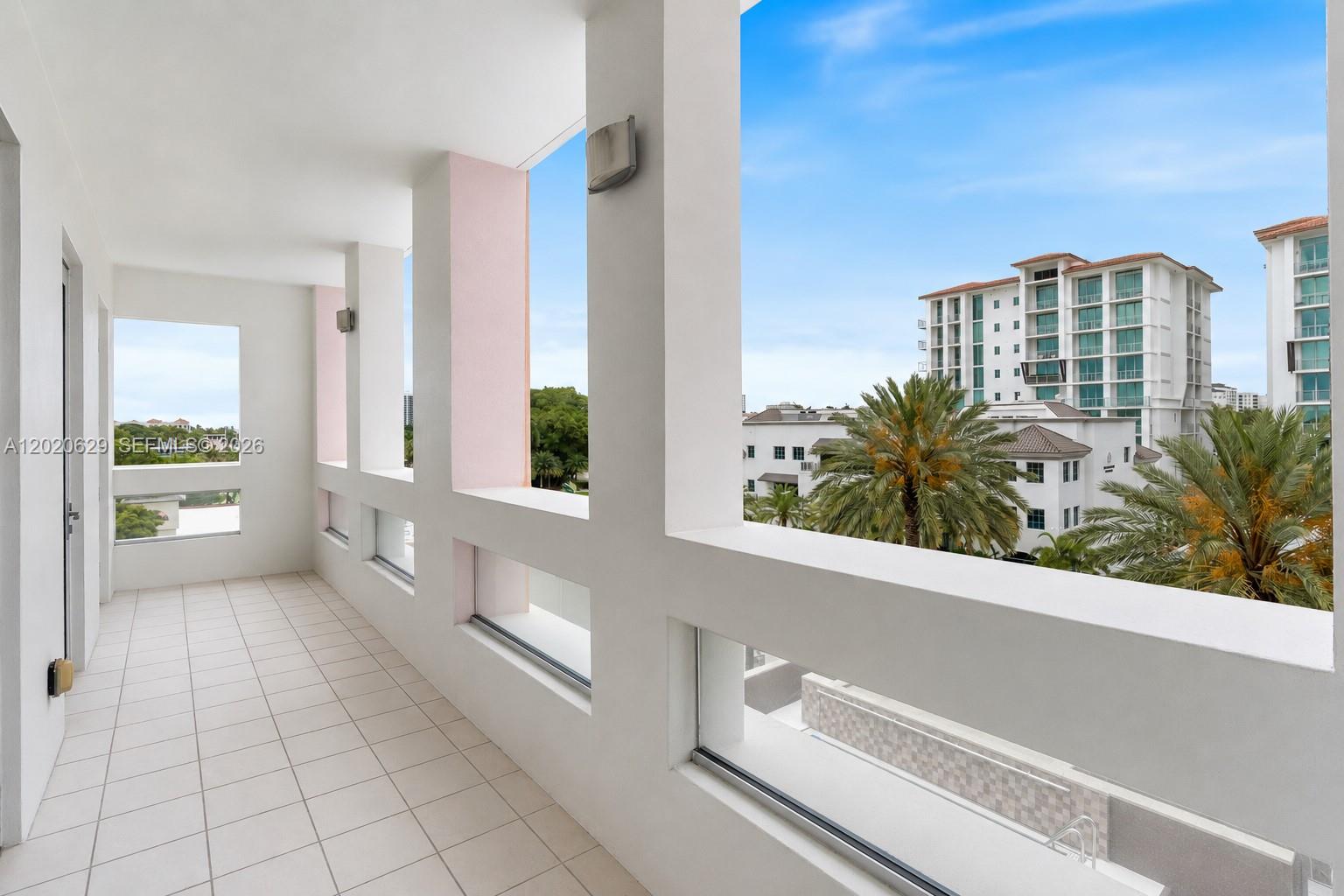 455 East Palmetto Park Road, Unit 4 Boca Raton, FL 33432 - Photo 6 of 30 a large white kitchen with cabinets