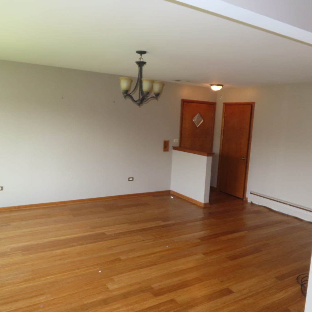 8316 Coral Drive Norridge, IL 60706 - Photo 13 of 42 a view of a room with wooden floor and cabinet