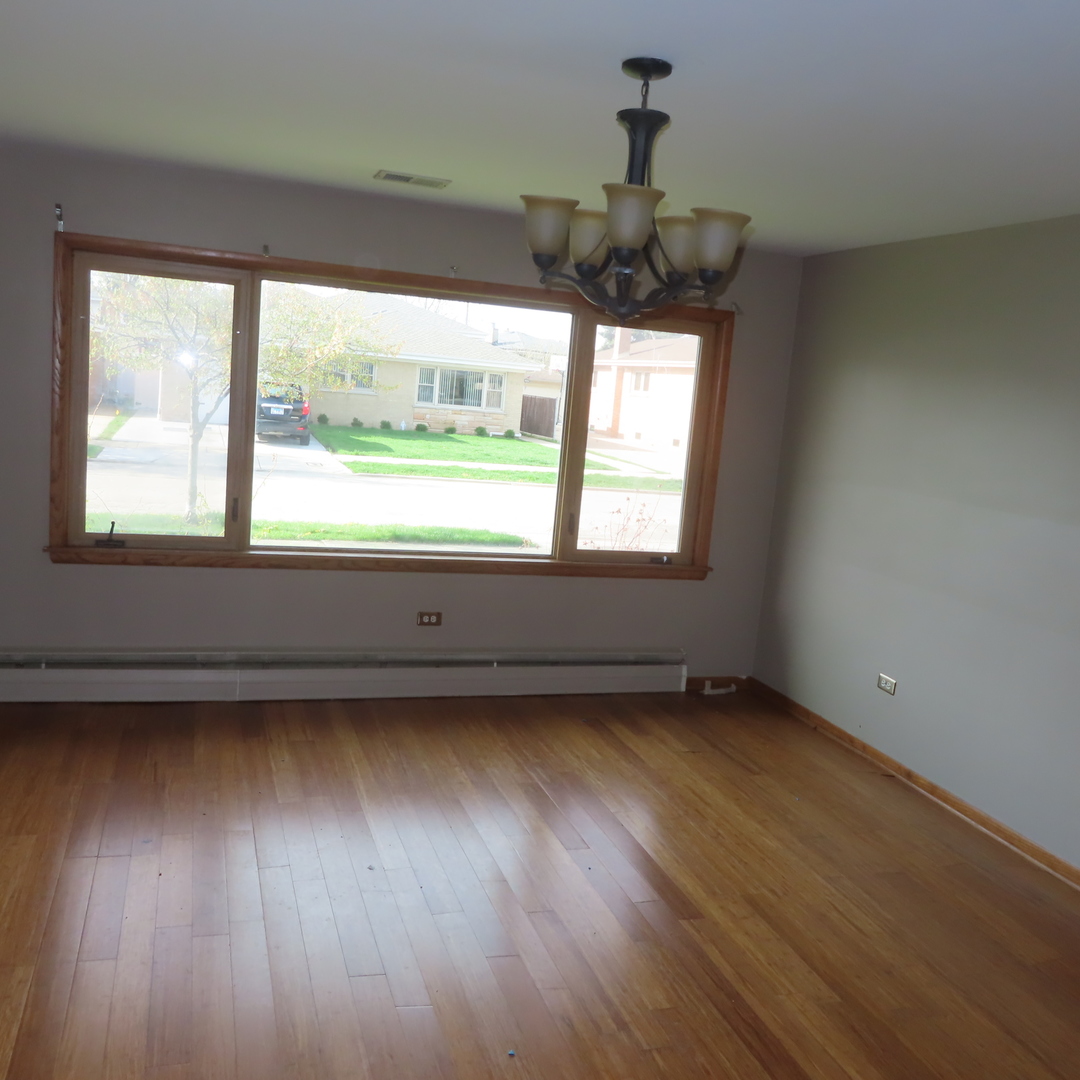 8316 Coral Drive Norridge, IL 60706 - Photo 14 of 42 an empty room with wooden floor and windows