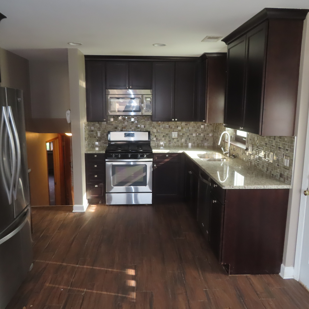 8316 Coral Drive Norridge, IL 60706 - Photo 17 of 42 a kitchen with stainless steel appliances a sink stove and refrigerator