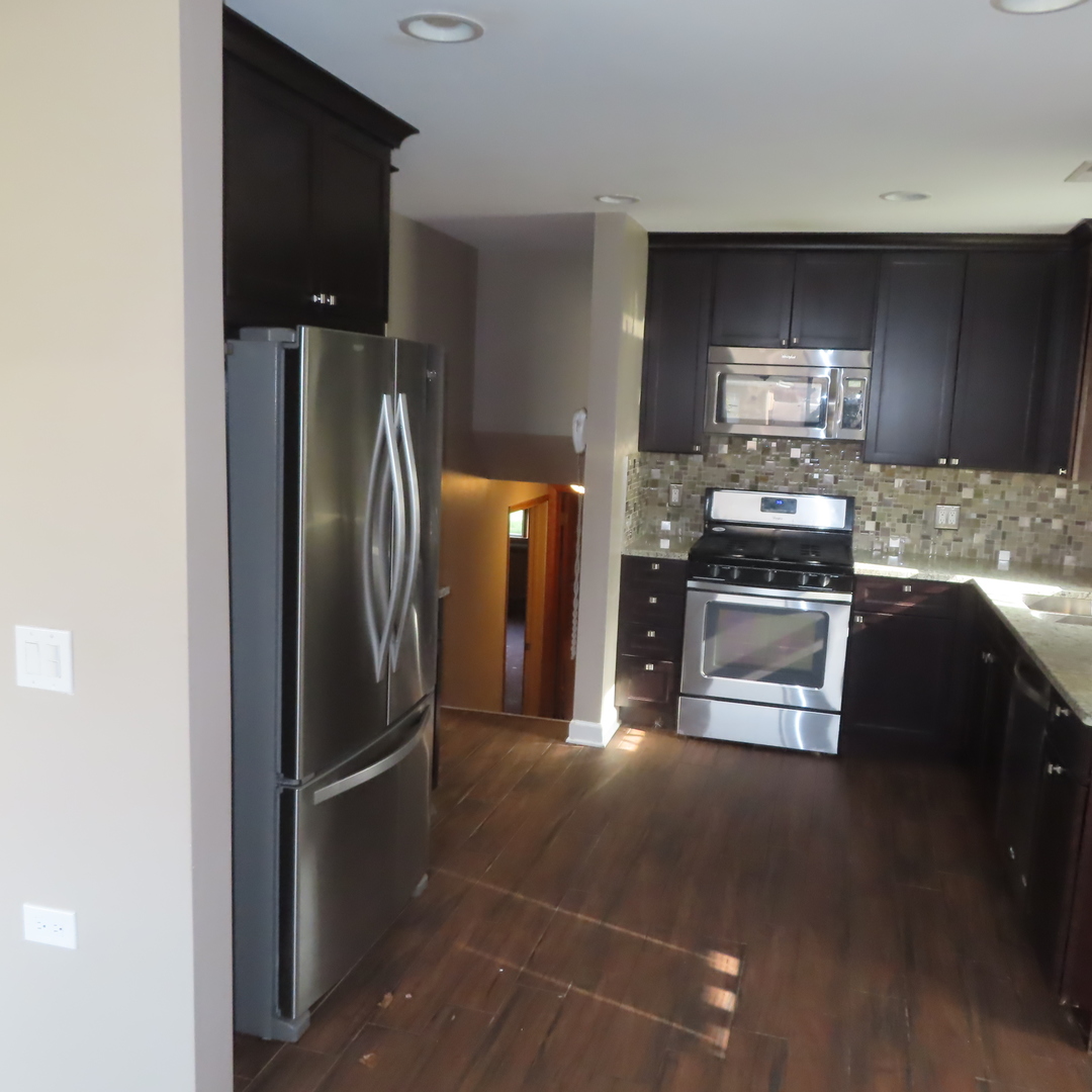 8316 Coral Drive Norridge, IL 60706 - Photo 18 of 42 a kitchen with stainless steel appliances granite countertop a refrigerator a stove and a sink