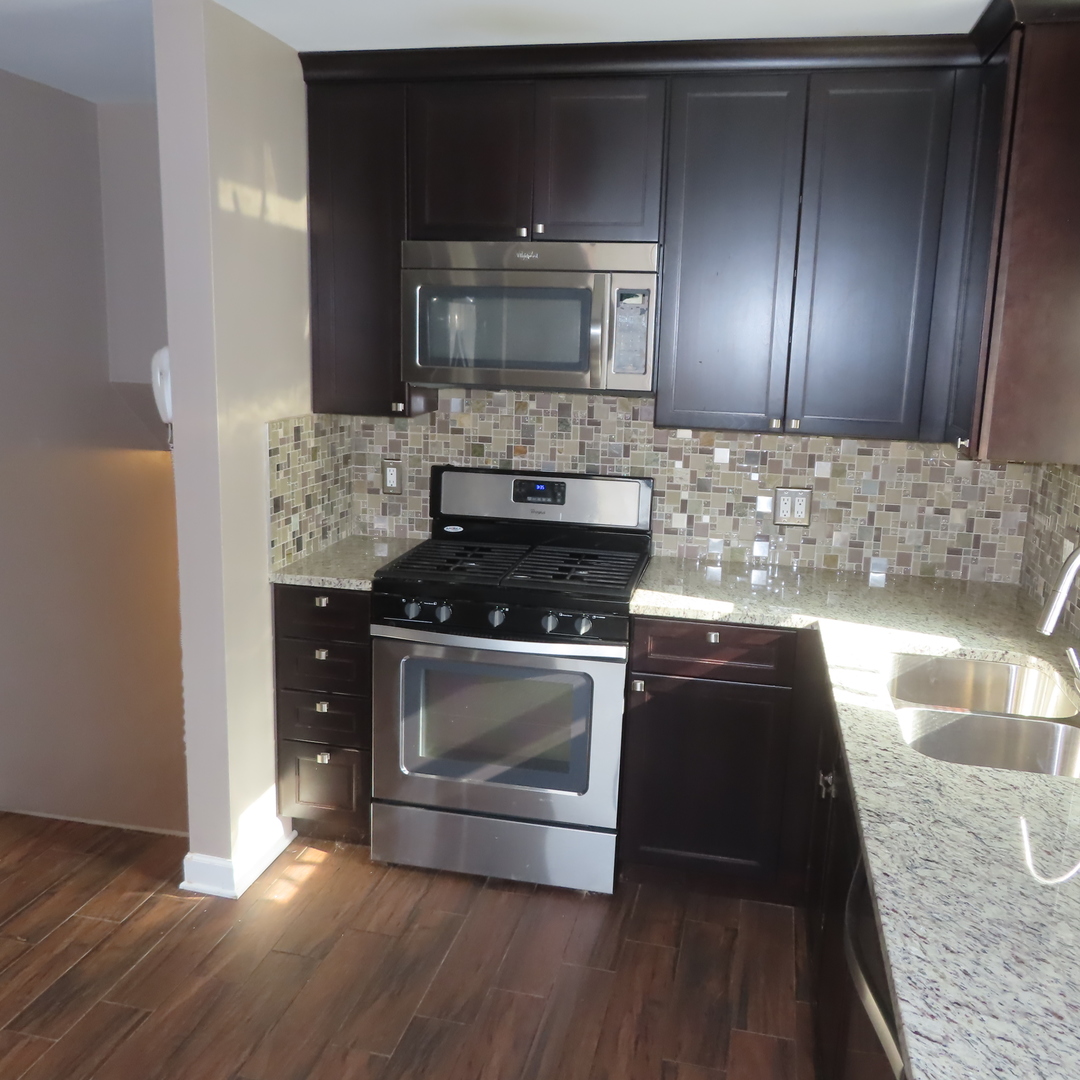 8316 Coral Drive Norridge, IL 60706 - Photo 20 of 42 a kitchen with a stove and a microwave