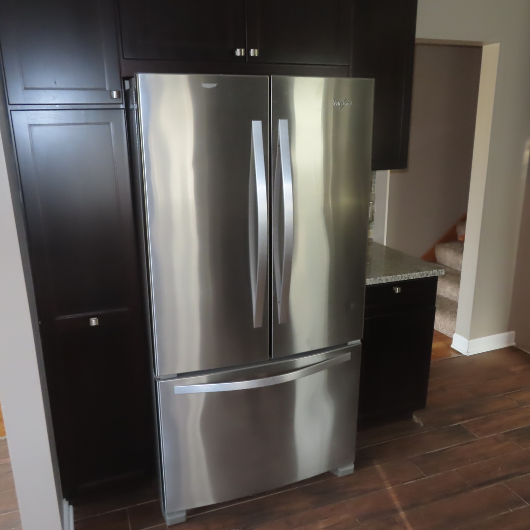 8316 Coral Drive Norridge, IL 60706 - Photo 21 of 42 a metallic refrigerator freezer sitting in a kitchen