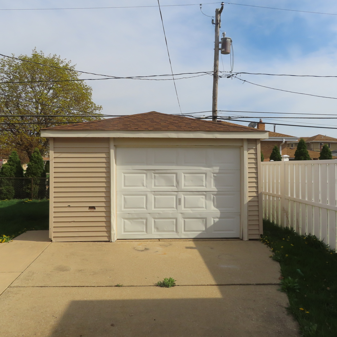 8316 Coral Drive Norridge, IL 60706 - Photo 37 of 42 a side view of a house with a garage