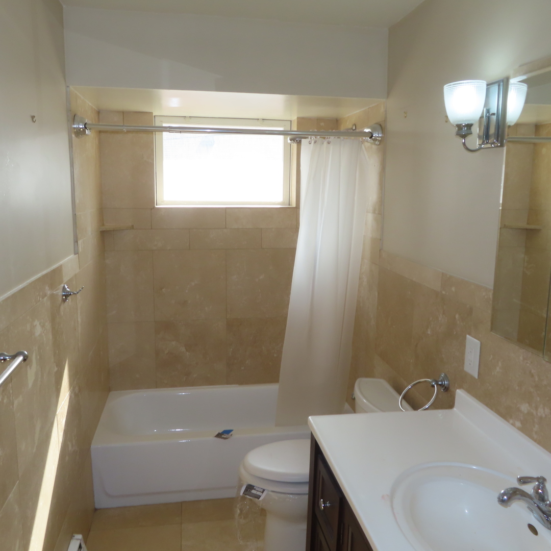 8316 Coral Drive Norridge, IL 60706 - Photo 5 of 42 a bathroom with a sink a toilet and shower